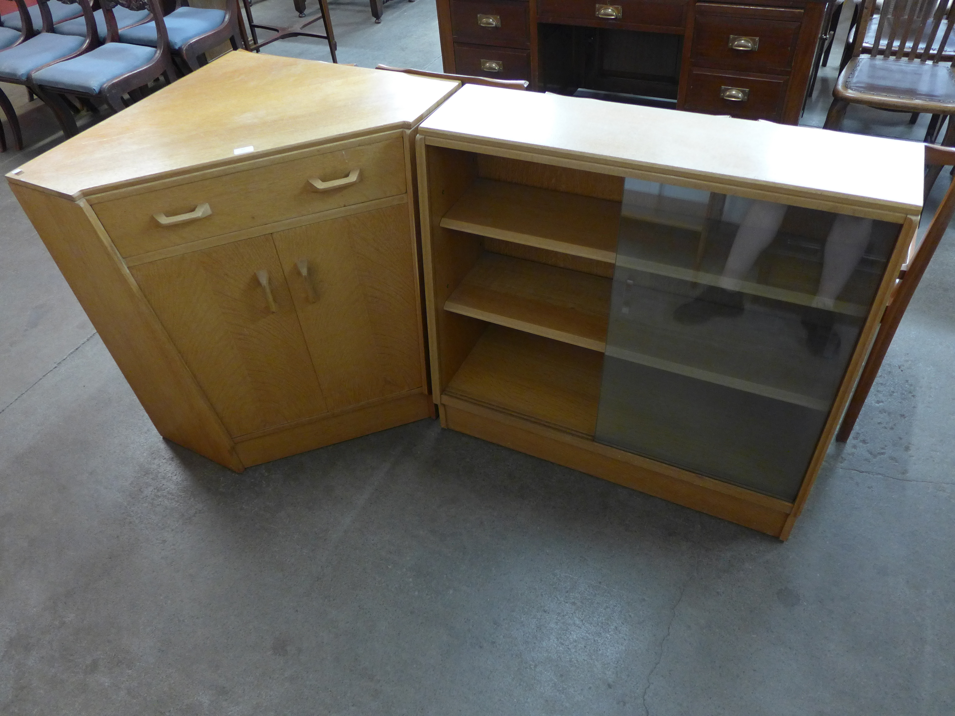 A G-Plan light oak corner cabinet and an oak bookcase