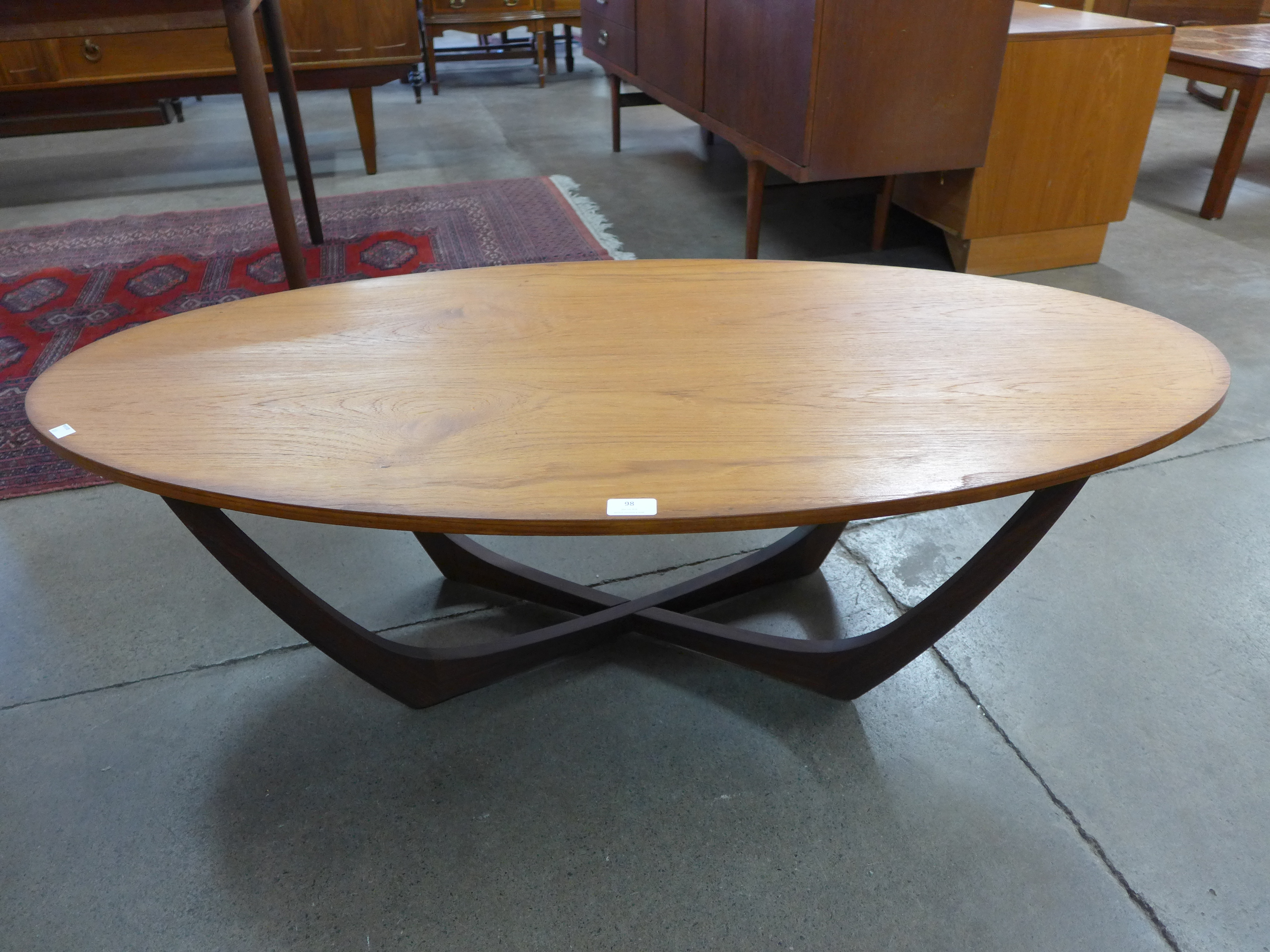 A teak and glass topped oval coffee table