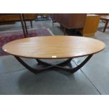 A teak and glass topped oval coffee table