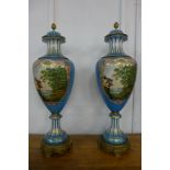 A pair of French style turquoise porcelain and gilt metal mounted vases and covers,