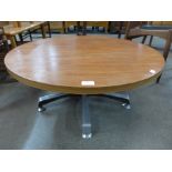 A teak circular coffee table on chrome stand