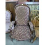 A Victorian beech and upholstered armchair