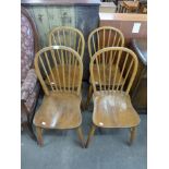 A set of four Ercol style elm seated chairs