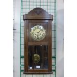 An oak cased wall clock