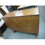 A teak drop leaf dining table