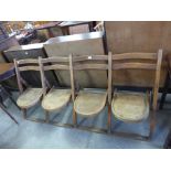 An oak folding four seat chapel bench