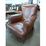 A Victorian mahogany and brown leather armchair