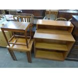 A teak record cabinet, magazine rack, occasional table, two open bookcases and a nest of tables