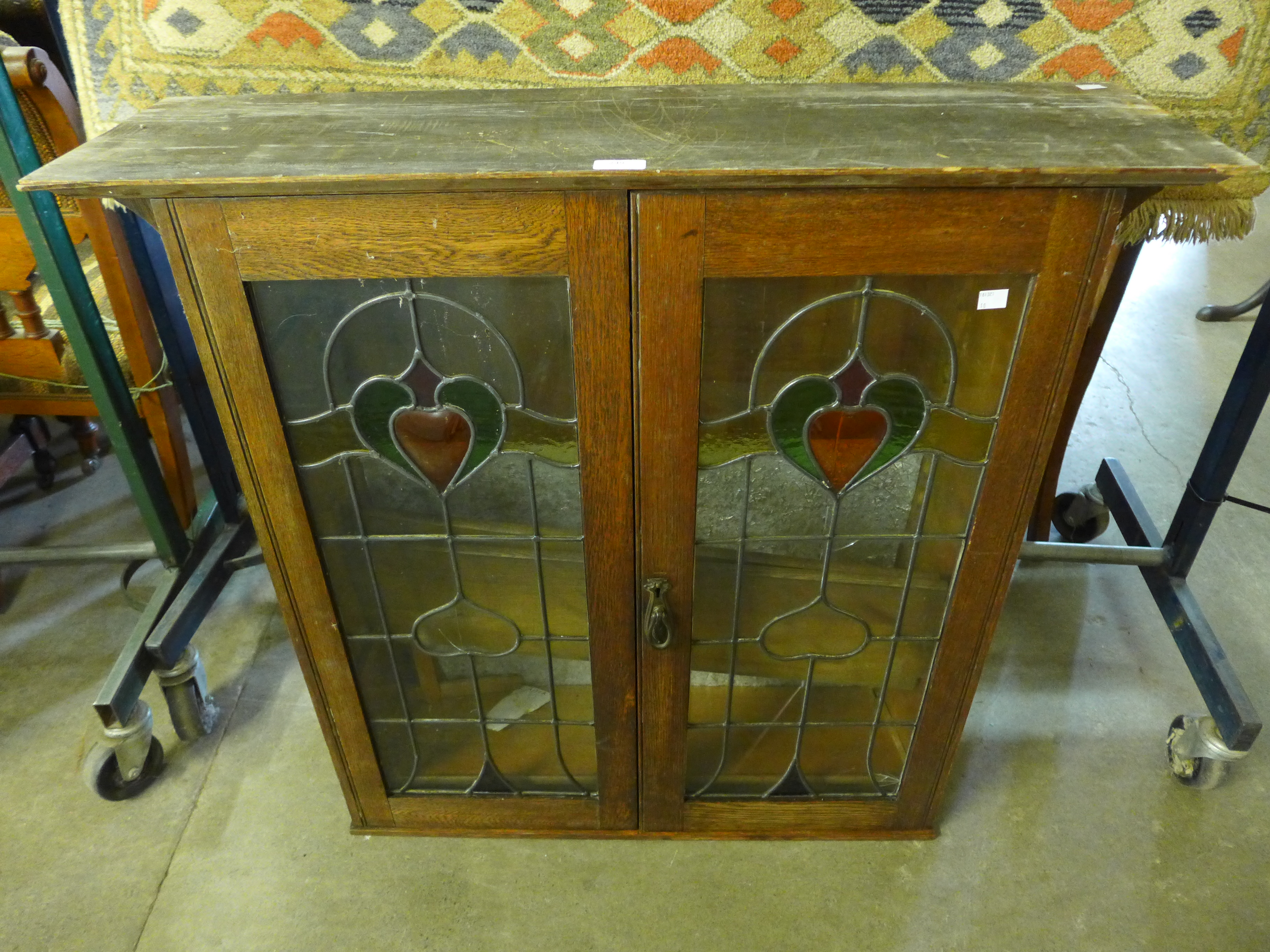 An Arts & Crafts stained glass and oak bookcase top