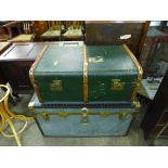 A banded travel trunk and a steamer trunk