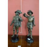 A pair of cast metal Cavalier figures on a wooden base