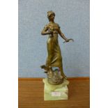 A spelter figure of a lady on an onyx base