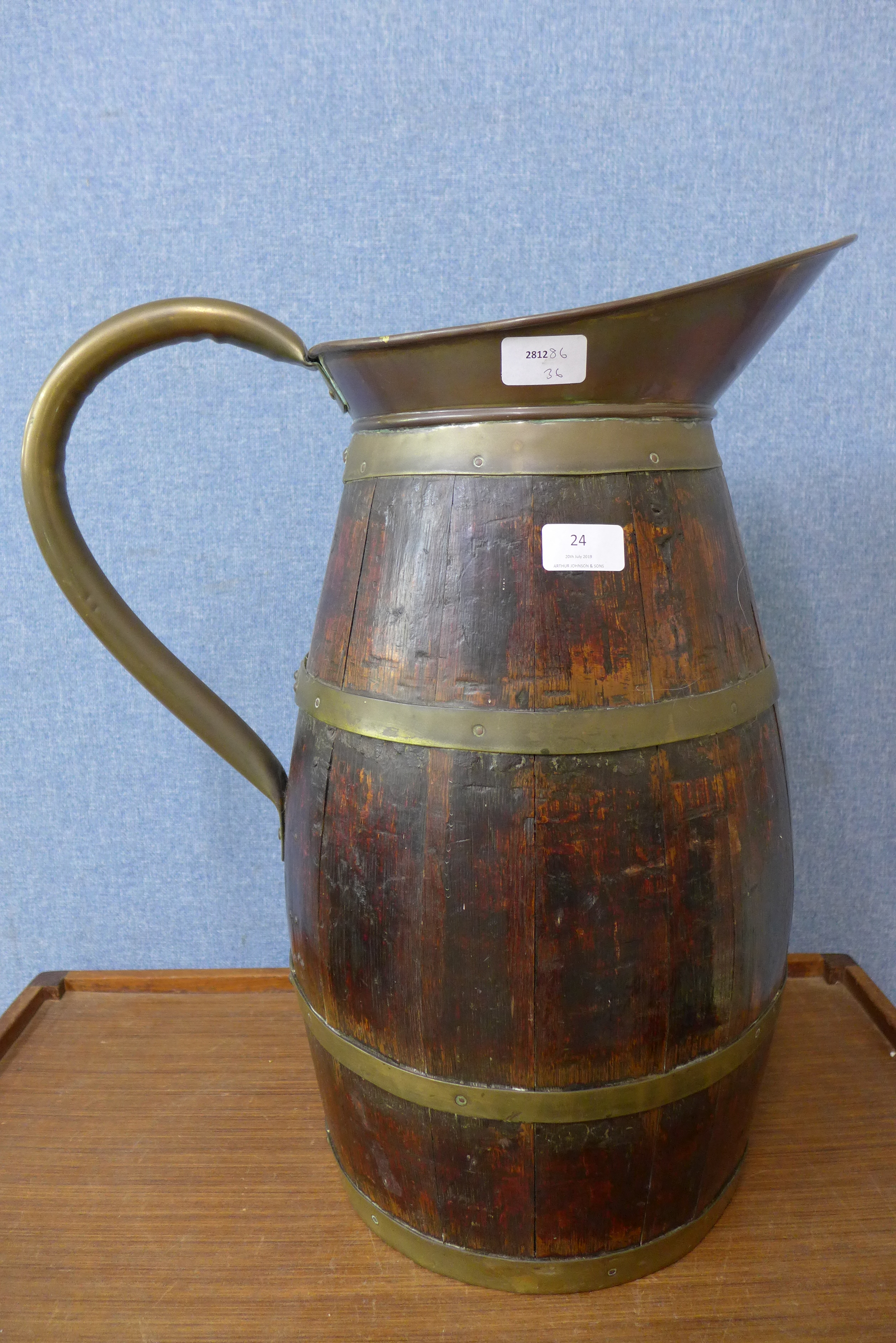 A coopered oak and brass bound jug stick stand