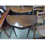 A pair of mahogany serpentine single drawer tables