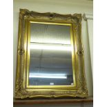 A rococo style gilt framed mirror