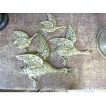 Four brass ducks