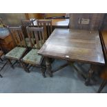 An oak draw-leaf dining table and four chairs