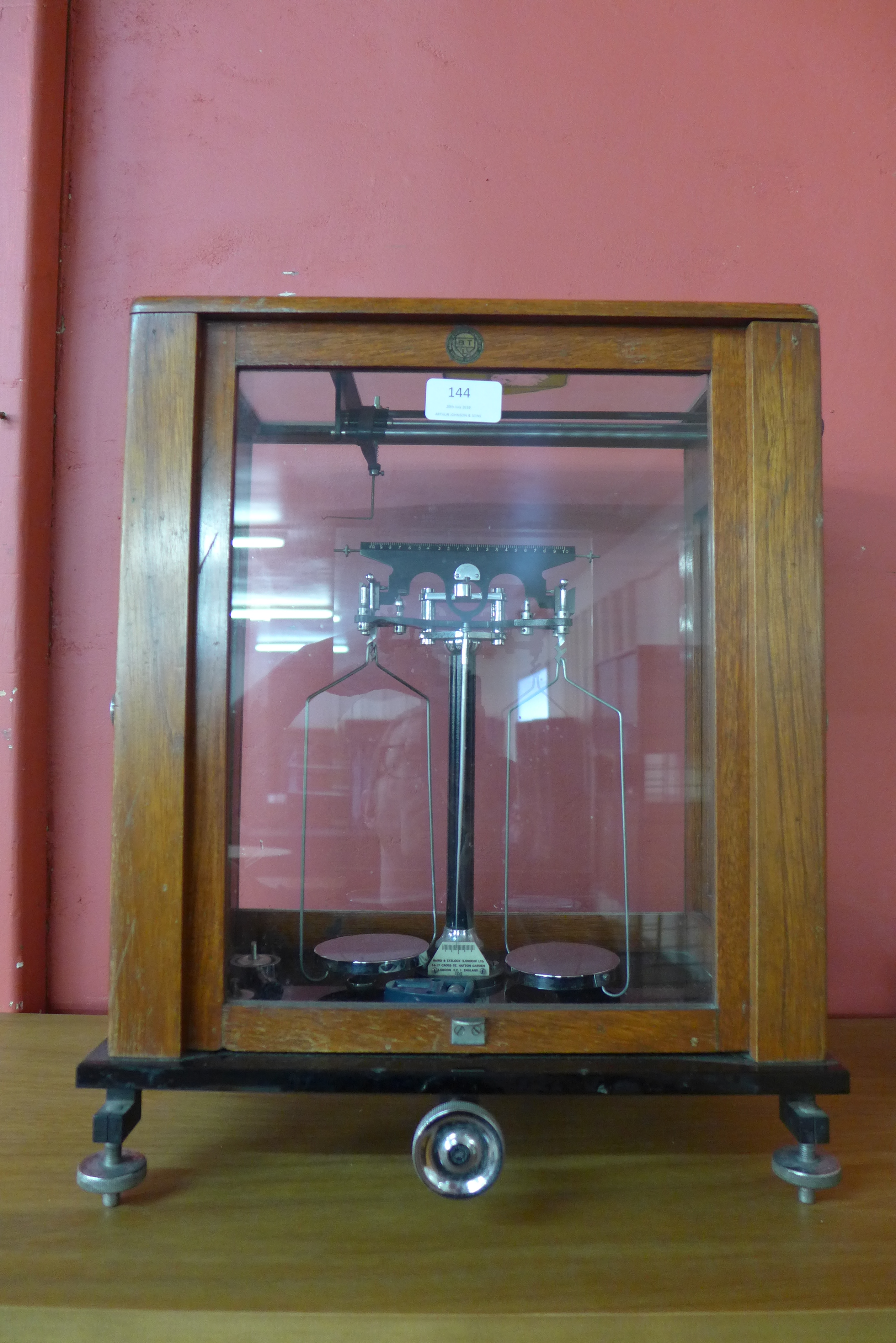 A mahogany and glass cased set of chemist balance scales