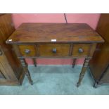 A Victorian mahogany three drawer side table
