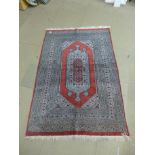 A red ground prayer rug,