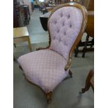 A Victorian walnut and upholstered nursing chair