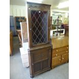 An oak freestanding corner cabinet