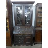 A Victorian Jacobean Revival carved oak bureau bookcase