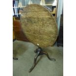 A George III oak circular tilt-top tripod table