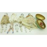 A collection of miniature dolls and an egg shaped container