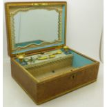 A lady's leather covered dressing table box with mirror, manicures and scent bottles,