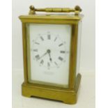 A brass and glass carriage clock, the dial marked J.W. Benson Ltd.