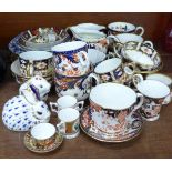 A collection of Royal Crown Derby cup and saucers, cream jugs, two paperweights, thimbles, etc.