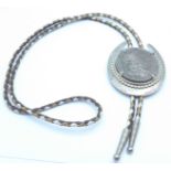A bolo tie with 1885 US dollar coin inset