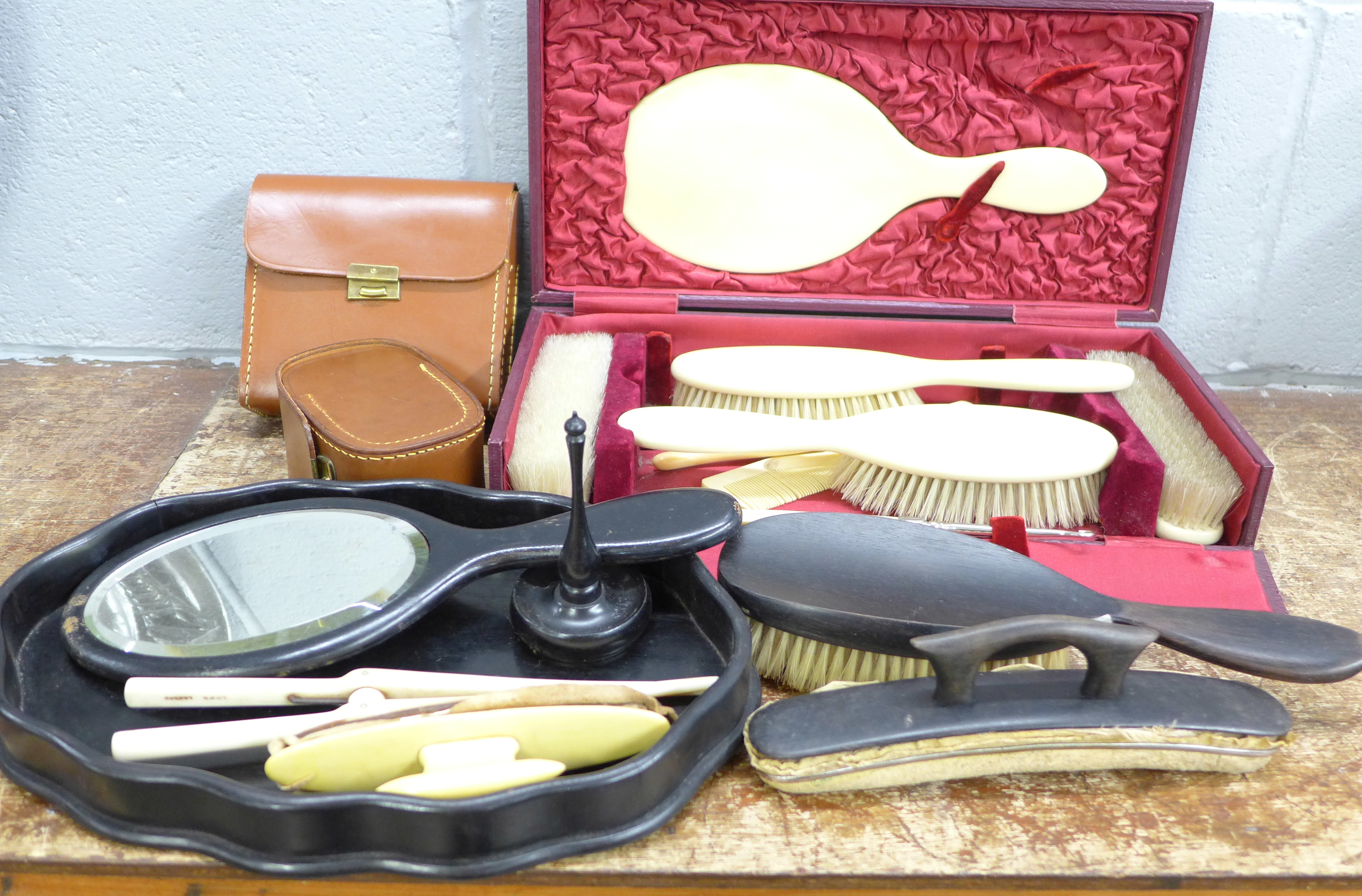Two vanity sets and two sets of brushes in leather cases