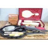 Two vanity sets and two sets of brushes in leather cases