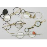 A pair of lorgnettes, spectacles and magnifying glasses,