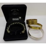 A silver bangle, two rolled gold bangles and a Celtic bangle made of pewter and silver,