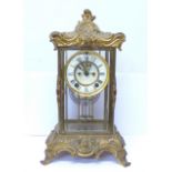 A 19th Century American rococo revival gilt metal and glass four sided clock, by Ansonia,
