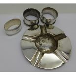 A silver ash tray, three silver napkin rings and a silver salt spoon,