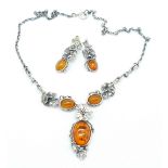 A sterling silver and amber necklet and matching earrings