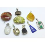 Eight pendants including silver mounted