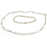 A silver neck chain and bracelet,