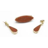 A pair of 9ct gold and goldstone earrings and an earlier goldstone set brooch