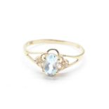 A 9ct gold, blue topaz and diamond ring, 1.