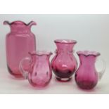 Four items of cranberry glass