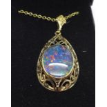 A 9ct gold and black opal pendant on chain, 10.