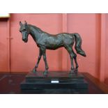 A bronze figure of a stallion