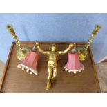 A pair of brass open barleytwist candlesticks and a cherub light fitting