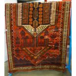 A Middle Eastern hand made red ground rug