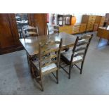 An oak refectory table and four ladderback dining chairs